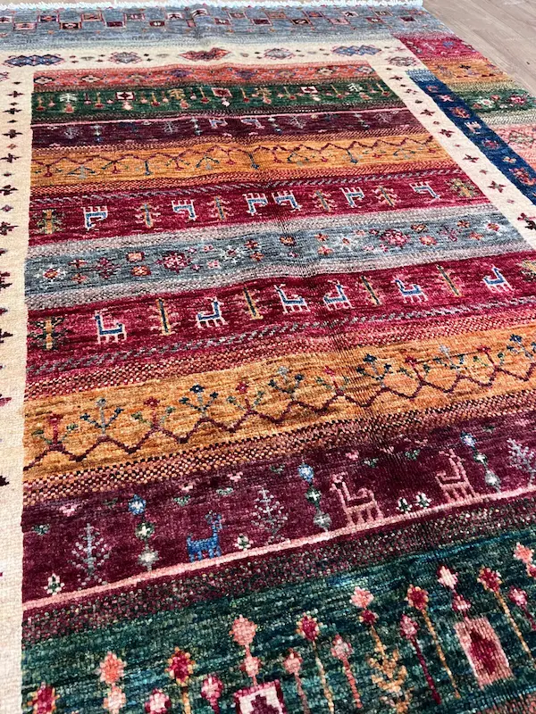 Colourful patterned rug with intricate designs.